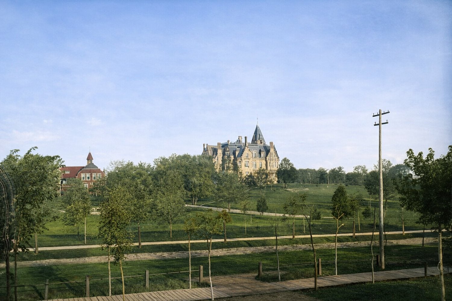 Colorized historic view of Fair Oaks, William D. Washburn's 40-room Minneapolis mansion, rising above its landscaped estate grounds