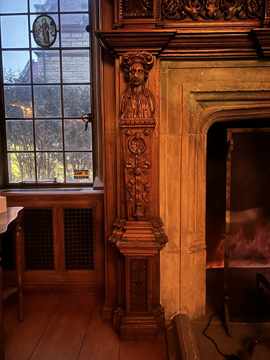 The stone fireplace and leaded glass today